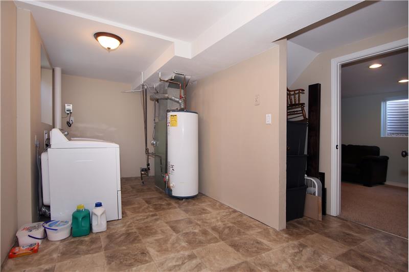 Large laundry room/storage area that is also plumbed for a sink