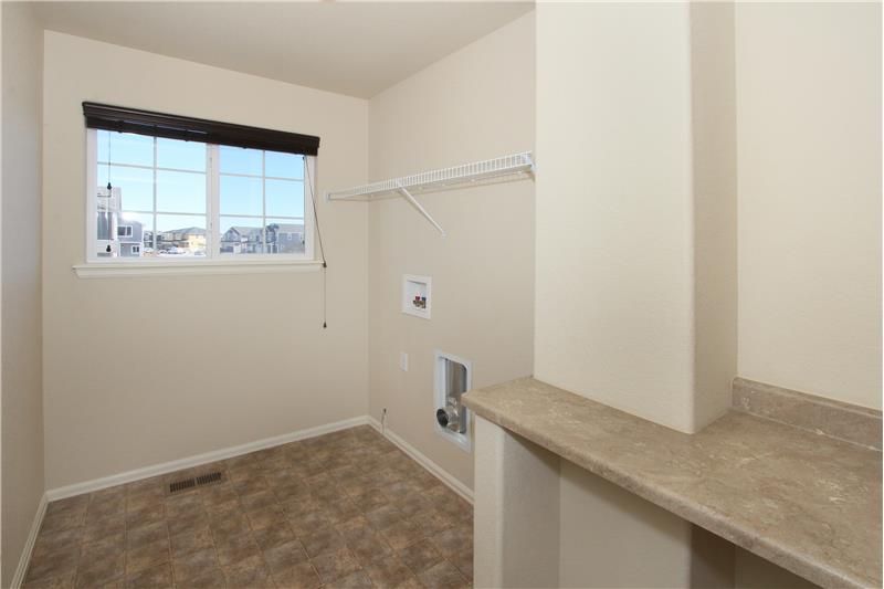 Upper level laundry room with window