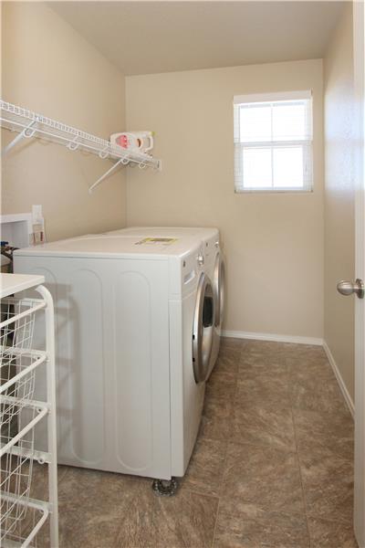 Upper level laundry room with a window