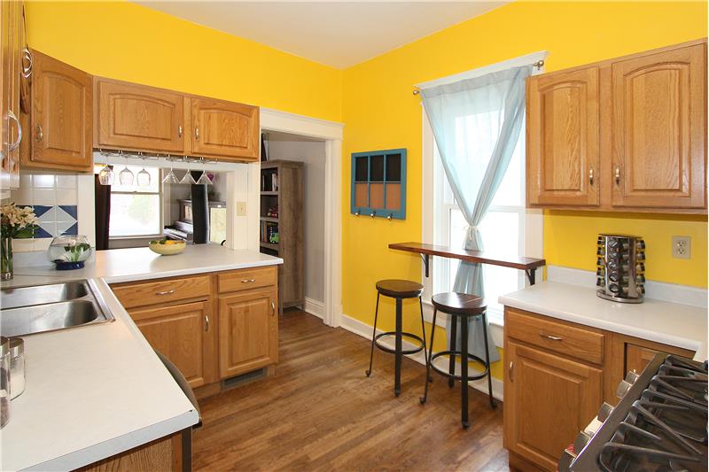 Open kitchen with ample counter top space and cabinet storage.  Convenient breakfast bar by window.