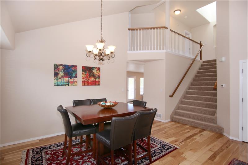 Formal dining room and view of the wide staircase leading upstairs