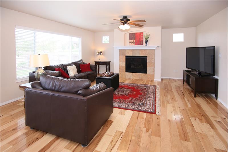 Family room with gas fireplace and ceiling fan