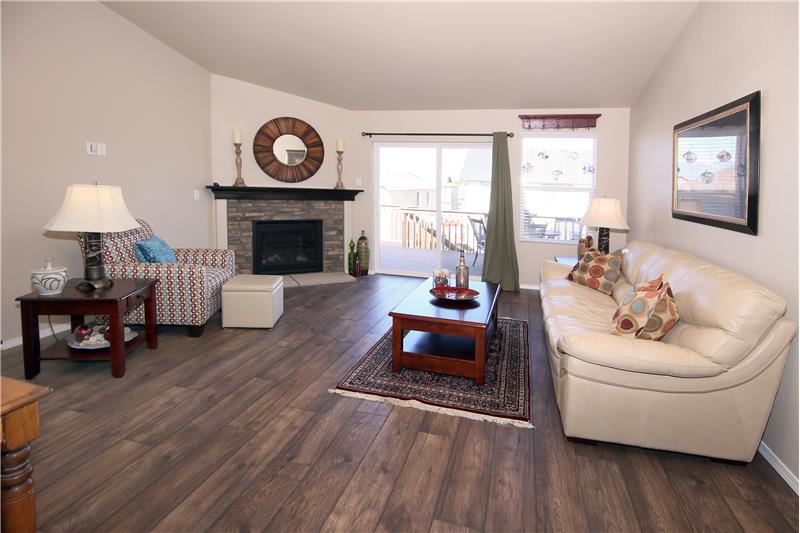 Living room with walk-out to back deck. Upgraded gas fireplace with stone, blower, and remote