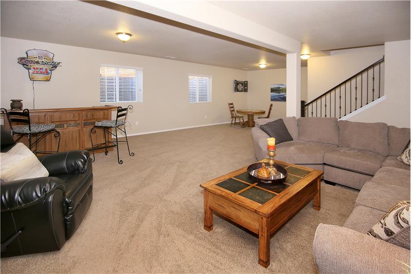 Bonus rec room and view of stair case with iron spindles
