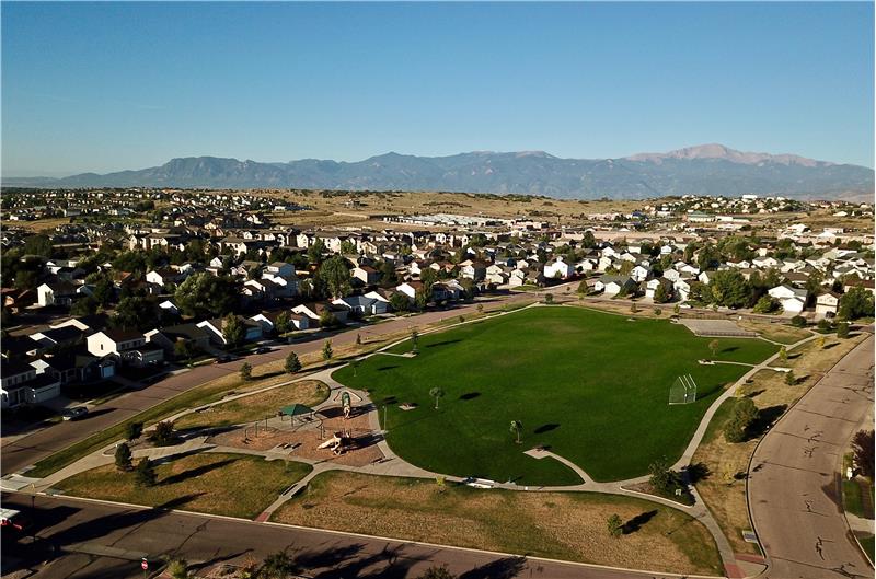 Aerial view of neighborhood park and mountains