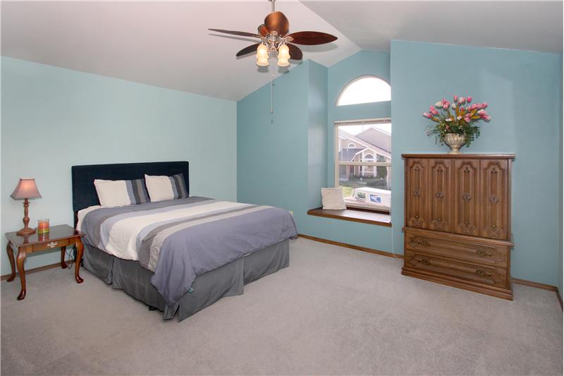 Large master bedroom with vaulted ceilings, ceiling fan. Enjoy Pikes Peak and mountain views from the window seat!