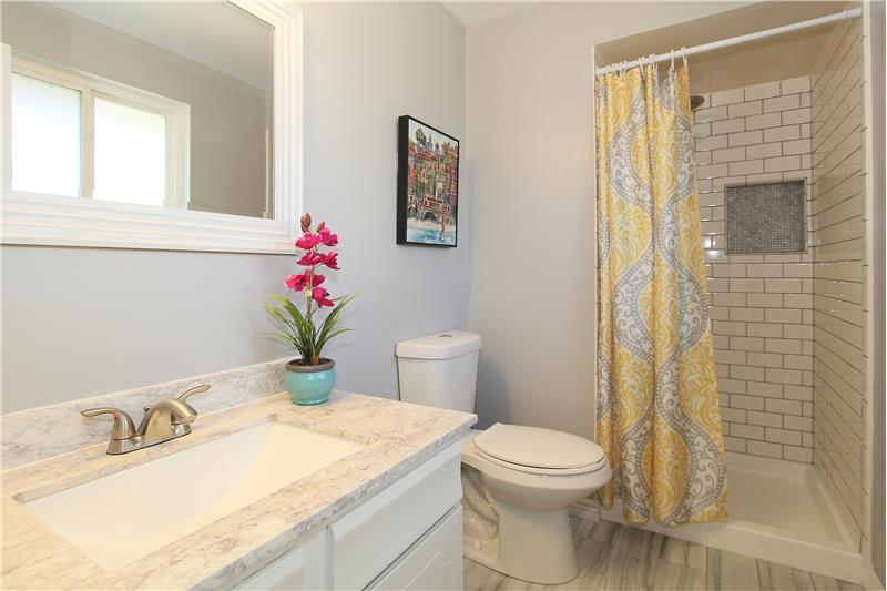 Updated master bath feels clean and contemporary with subway tile