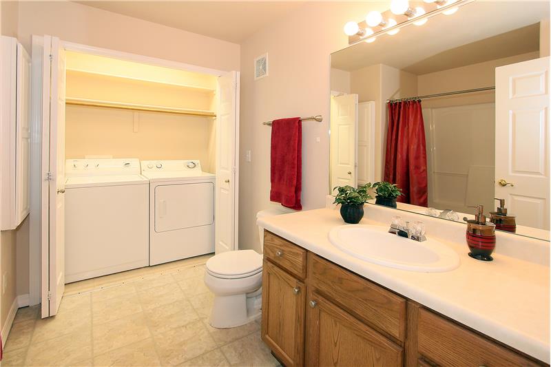 Full bath with new flooring, laundry, and built-in ironing board