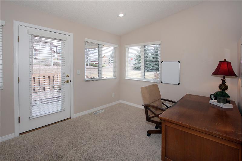 Office provides walk-out to covered back patio