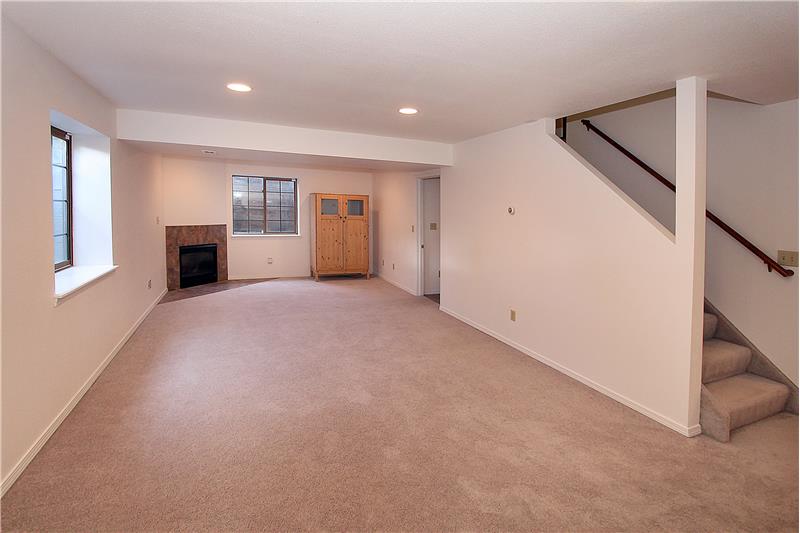 Large basement rec room with gas fireplace, recessed lighting, and new paint