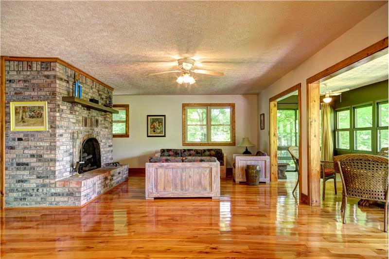 Living Room, Fireplace, Deck and Enclosed Porch Kitchen with View to River at 283 Walleye Rd, Falls of Rough