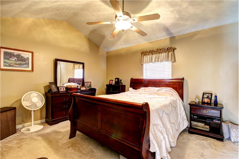 Bedroom with vaulted ceiling and fan