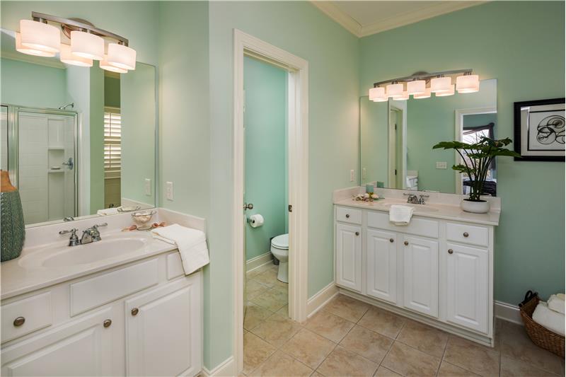 Master Bath has New Light Fixtures, Tile Flooring, separate raised Vanities, private Toilet Closet