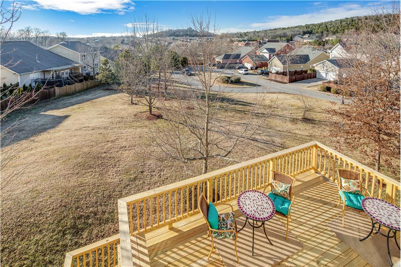 View from Bonus Room overlooking New Deck, open commons area, shopping area, rolling hills in distance