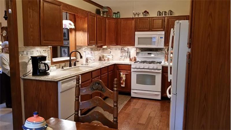 8055 Foxchase Dr, - Kitchen has granite counter tops and tile backsplash