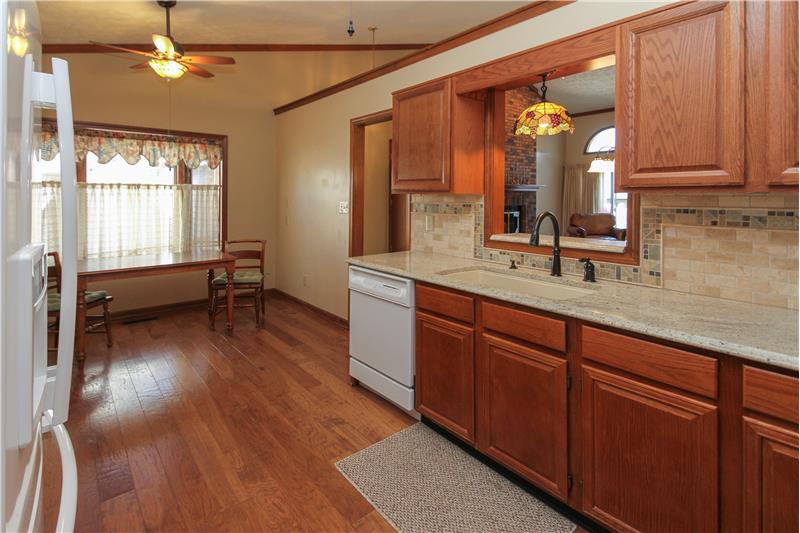8055 Foxchase Dr, - Engineered hardwood floor, granite counter top & tile backsplash.