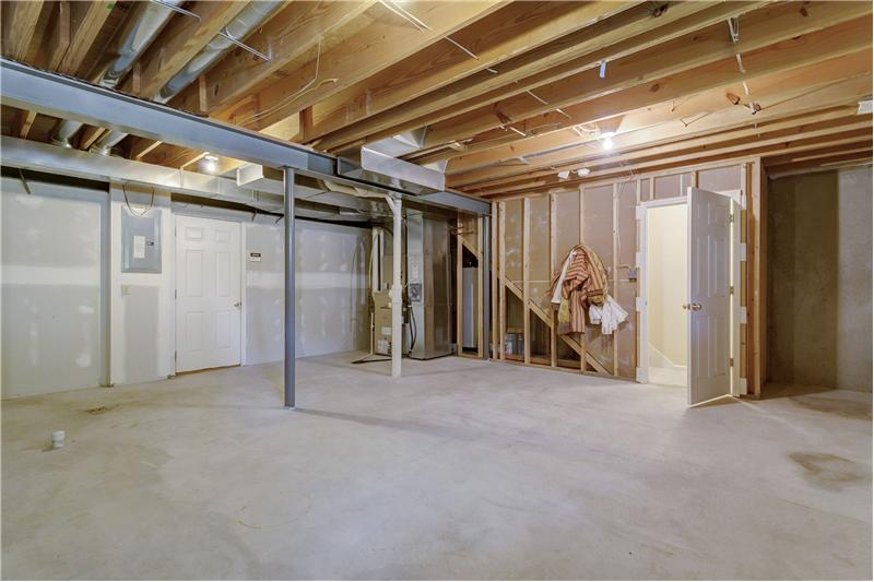 Spacious unfinished Basement with a full Bath rough-in