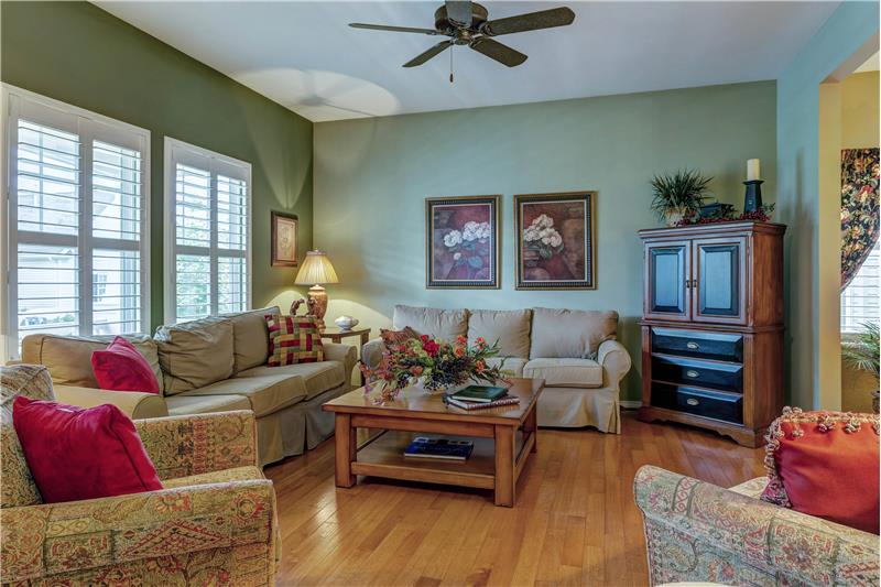 Great room with wood floor, plantation shutters