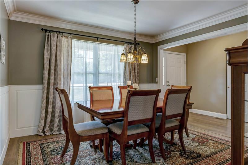 Dining room with crown molding and wainscoting