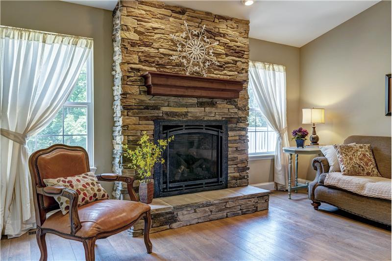 Handsome custom stone fireplace with raised hearth