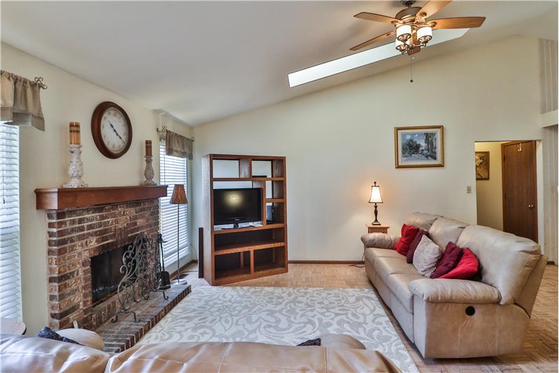 Great room has Vaulted Ceiling & Fan