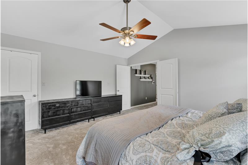Master has a vaulted ceiling, fan, walk-in closet