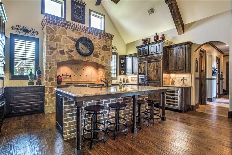 Kitchen features stained grade doors, stonework, trim and built ins.