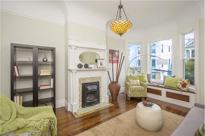 The living room with gas insert fireplace and ornate surround could serve as the heart of the home or just as easily double as a