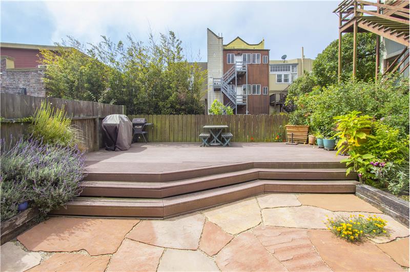 To the rear of the building is a huge south-facing communal outdoor space with a paved area & raised deck. 