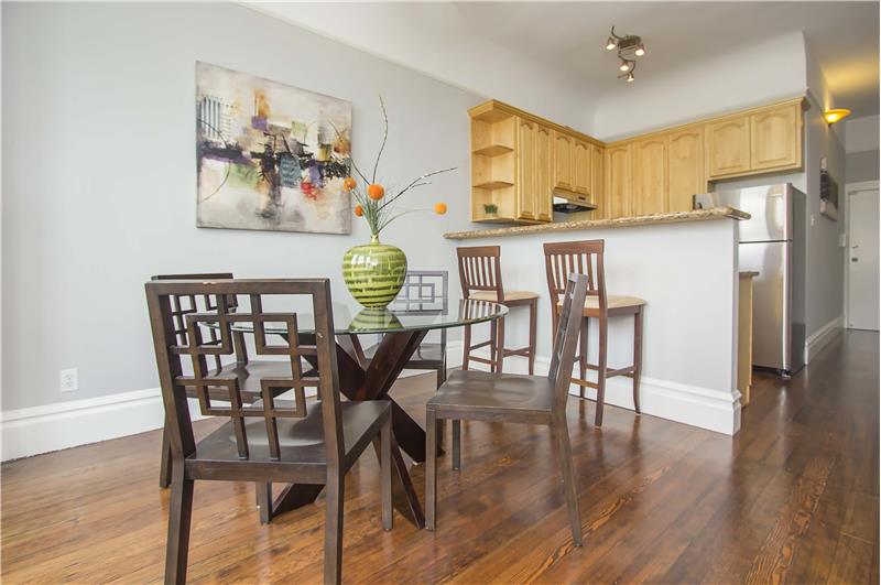 Beautiful wood floors lead the way to a kitchen that features both a breakfast bar and separate dining area.