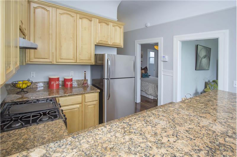 Traditional coving and trim details line the hallway, leading from the kitchen to the bedroom.