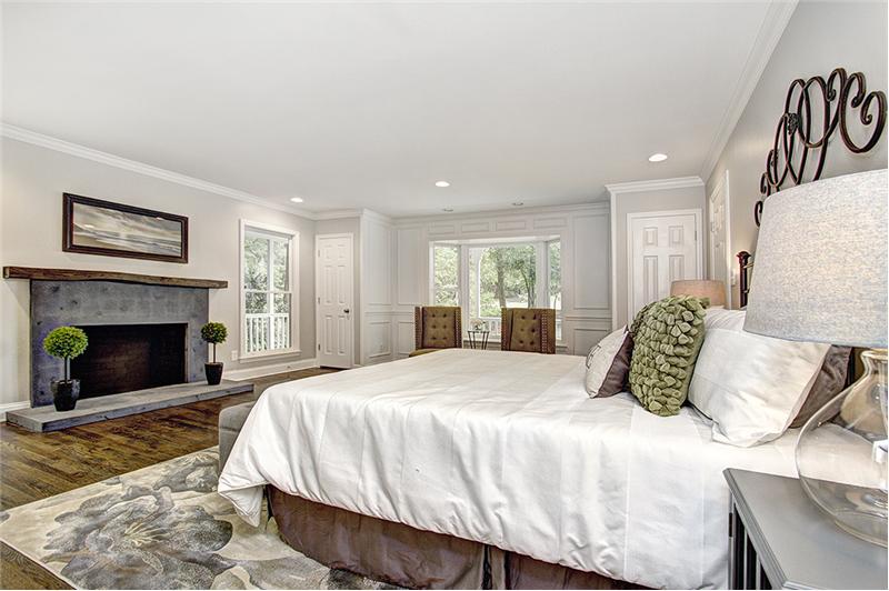The spacious main-level master suite has a wood burning fireplace
