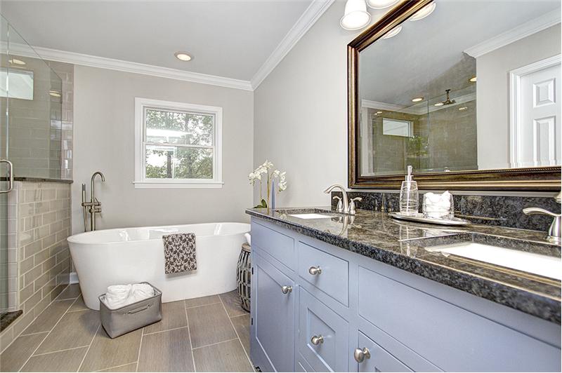 Luxurious master bathroom has granite counter tops, dual sinks, a free standing tub & LARGE enclosed shower