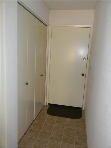 The laundry is inside behind the closet doors. The other door leads to the garage.