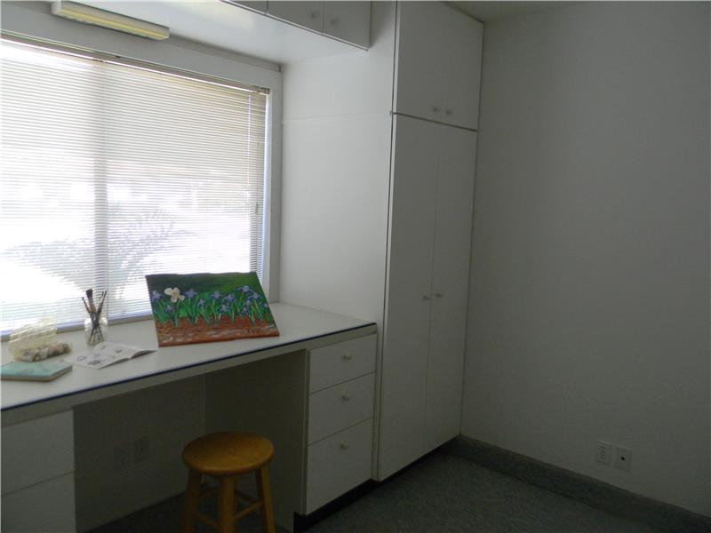 Wonderful craft room or office with tons of cupboards!