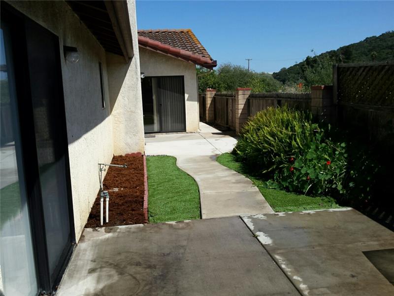 2 patios and cement walkways and artificial grass make for an easy care backyard!