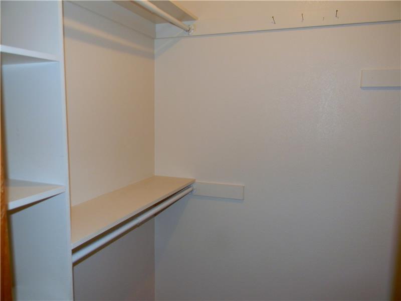 Both bedrooms feature walk in closets with clothing poles on both sides of the closets.