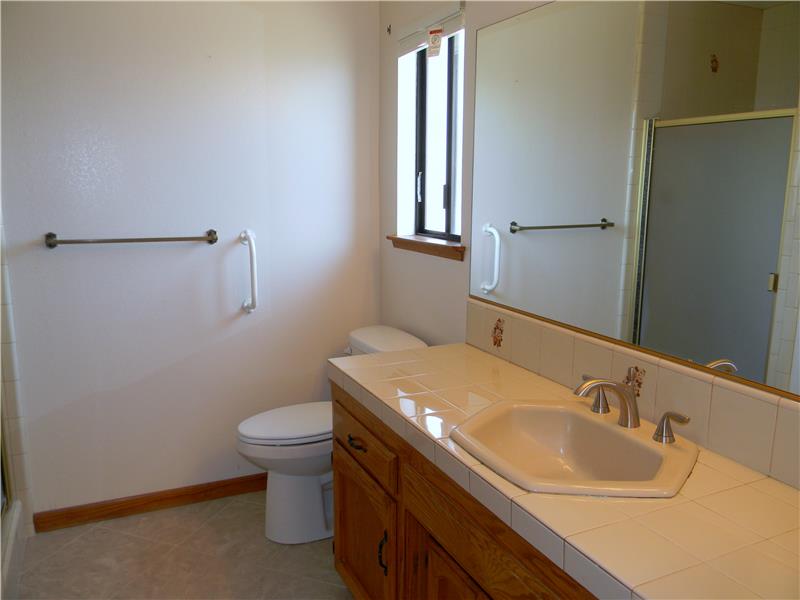 This bathroom features a newer comfort height low flow toilet and a newer faucet.
