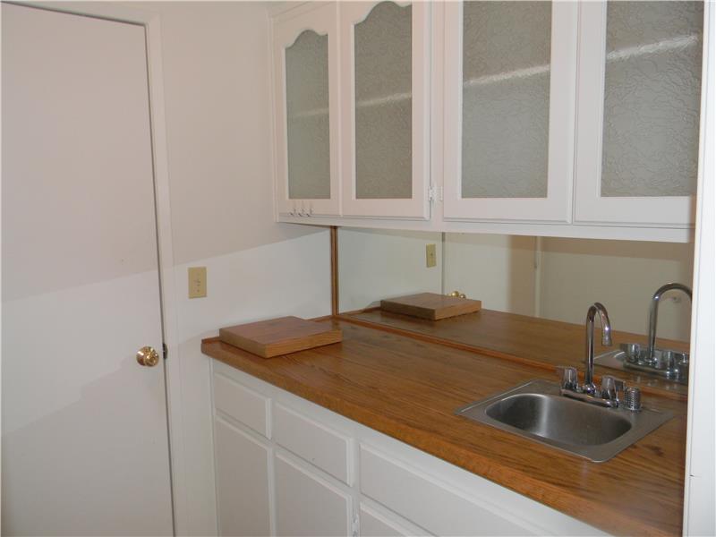 The laundry room was converted to a wet bar with a sink and more cupboards