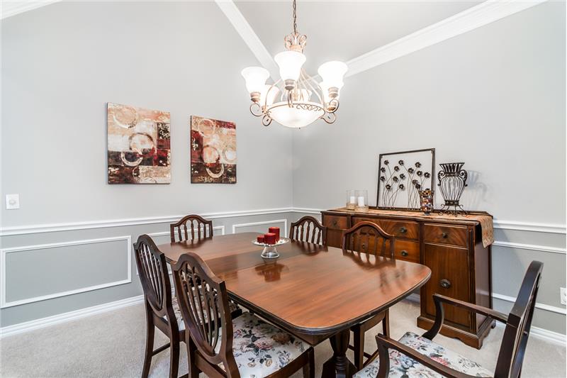 Formal dining room with fresh grey paint throughout the home.