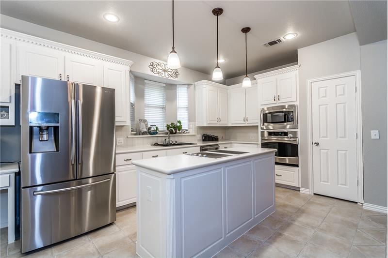 Gorgeous updated kitchen with beautiful white cabinets and updated hardware and lighting.