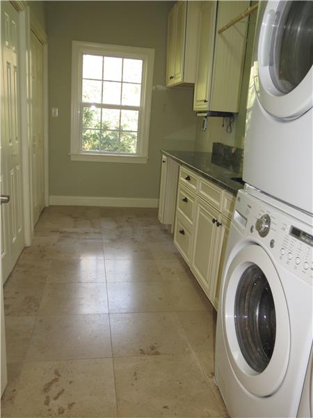 Large laundry room w cabinets tile floors window...