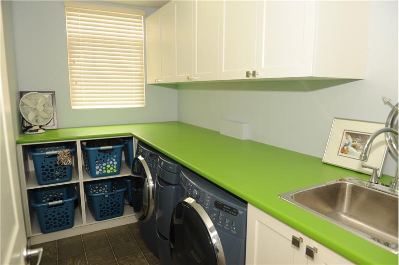 Laundry with front load washer & dryer, plus custom storage