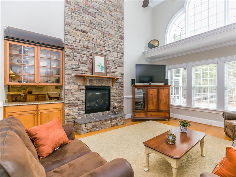 Two Story Living Room with Stacked Stone Fireplace