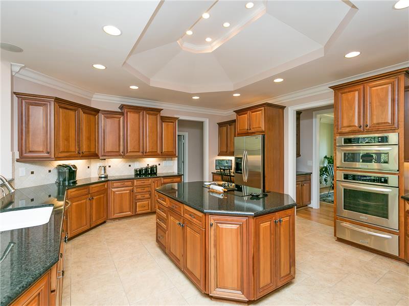 Custom Cabinetry with Over/Under Lighting and Trey Ceiling in Spacious Kitchen