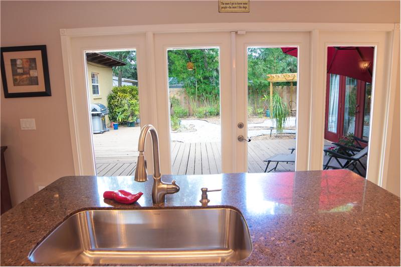 Kitchen with large island overlooking the backyard oasis