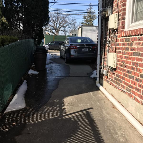 Side of house leads to parking area.