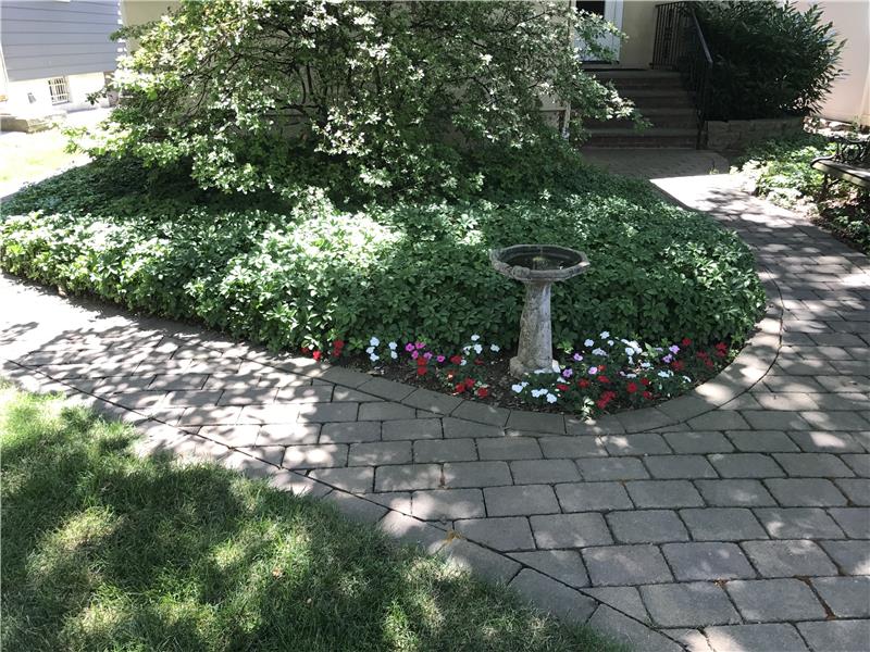 Paver stone walkway and beautiful garden.