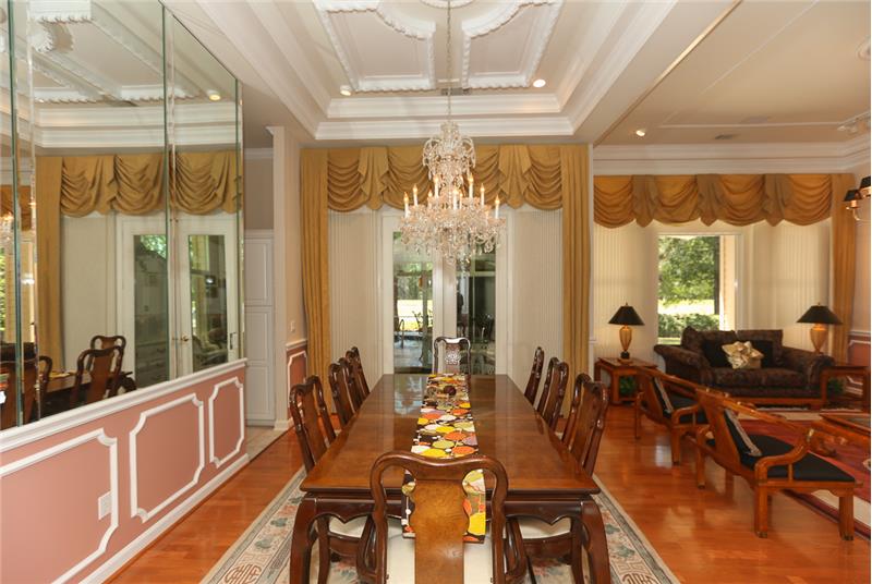 Look at the lovely double crown molding in the tray ceiling with embellished ceiling medallion above the chandelier. Invite your