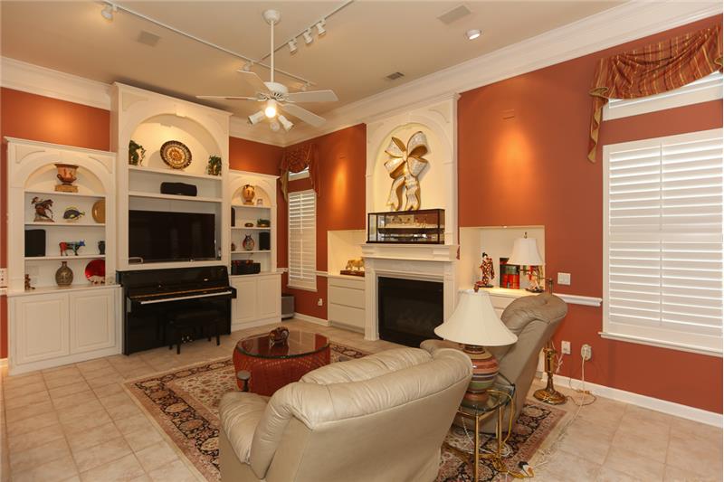 The great room offers a gas fireplace, built-in custom cabinetry to display your favorite collection of artwork, & storage cabin